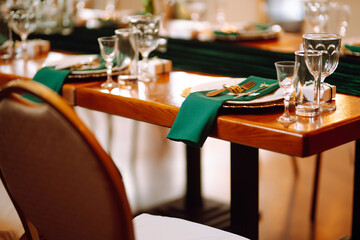 Wedding. Banquet. Beautiful table setting for a party, wedding reception or other festive event emerald colour.