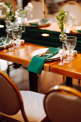 Wedding. Banquet. Beautiful table setting for a party, wedding reception or other festive event emerald colour.