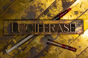 Luciferase text with syringe on vintage textured grunge copper and gold background