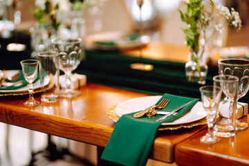Wedding. Banquet. Beautiful table setting for a party, wedding reception or other festive event emerald colour.