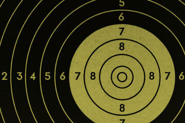 Target for shooting. Khaki or green tinted background or wallpaper. Dark inverted backdrop about...