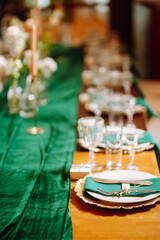 Wedding. Banquet. Beautiful table setting for a party, wedding reception or other festive event emerald colour.