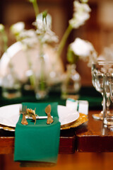 Wedding. Banquet. Beautiful table setting for a party, wedding reception or other festive event emerald colour.
