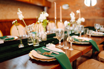 Wedding. Banquet. Beautiful table setting for a party, wedding reception or other festive event emerald colour.