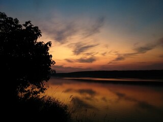 Fototapeta na wymiar Colorful sunset over the river