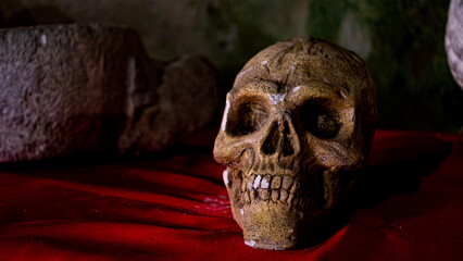 stone skull on red cloth