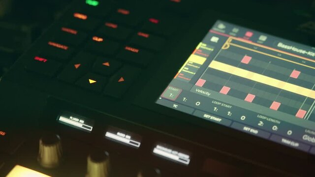 Traveling on the screen of a synthesizer in which we see a representative graphic of a house sequence. We also see the buttons in a close-up and the play line running, a mixer fader