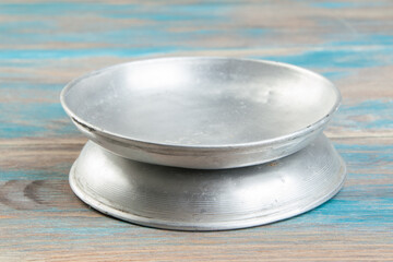 Old metal plates for scales on wooden background.