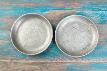Old metal plates for scales on wooden background.