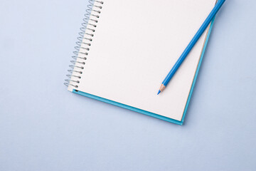 Empty notebook ready for mockup on blue table, top view, flatlay.