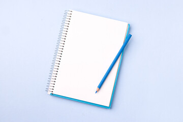 Empty notebook ready for mockup on blue table, top view, flatlay.