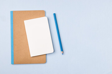 Empty notebook ready for mockup on blue table, top view, flatlay.