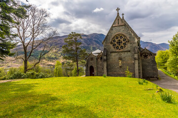 Fototapeta na wymiar A view towards a church above Glenfinnan, Scotland on a summers day