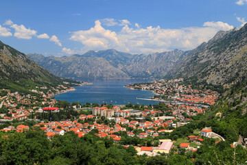 Fototapeta premium Full view of the beautiful Kotor Bay and the old city Kotor surrounded by high mountains in Montenegro in summer
