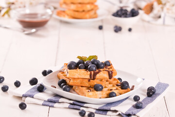 Waffles with blueberries and chocolate cream. 