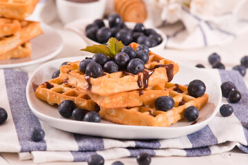 Waffles with blueberries and chocolate cream. 