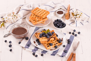 Waffles with blueberries and chocolate cream. 