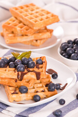 Waffles with blueberries and chocolate cream. 