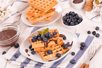 Waffles with blueberries and chocolate cream. 