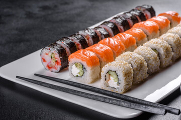 Delicious fresh rolls in various sets. Japanese food with avocado, shrimp, crab and salmon