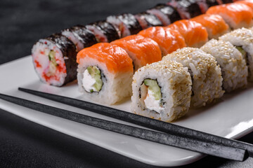 Delicious fresh rolls in various sets. Japanese food with avocado, shrimp, crab and salmon