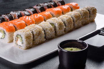 Delicious fresh rolls in various sets. Japanese food with avocado, shrimp, crab and salmon
