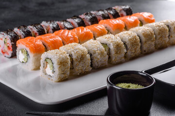 Delicious fresh rolls in various sets. Japanese food with avocado, shrimp, crab and salmon