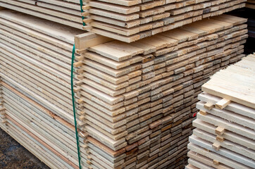 large stacks of wooden planks at the building material depot.