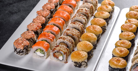 Delicious fresh rolls in various sets. Japanese food with avocado, shrimp, crab and salmon