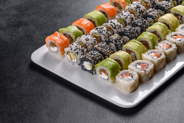 Delicious fresh rolls in various sets. Japanese food with avocado, shrimp, crab and salmon