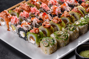 Delicious fresh rolls in various sets. Japanese food with avocado, shrimp, crab and salmon