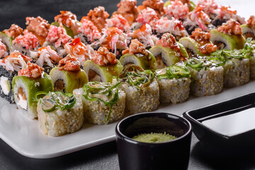 Delicious fresh rolls in various sets. Japanese food with avocado, shrimp, crab and salmon