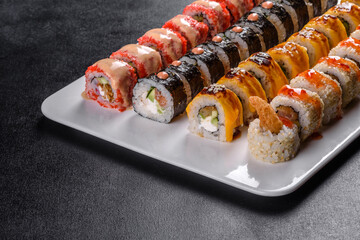 Delicious fresh rolls in various sets. Japanese food with avocado, shrimp, crab and salmon