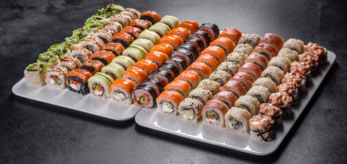 Delicious fresh rolls in various sets. Japanese food with avocado, shrimp, crab and salmon