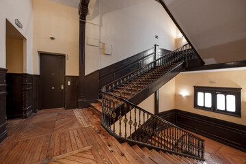 Pine wood stairs and parquet flooring in an old building in the center of a European city