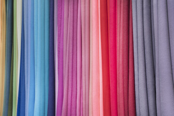 Stack of multicolored fabric Textile industry, background texture with assorted rainbow color textile samples