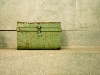 Vintage, closed metallic chest, travel trunk. Green colour.