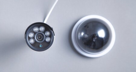 Two security camera on gray background.