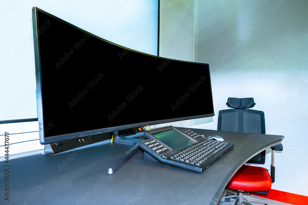 Poster monitor in dispatching office. large monitor near control panel. switched off monitor next to contro
