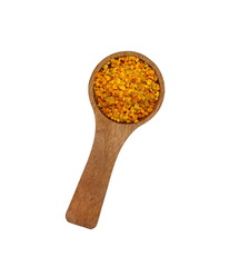 Pile of bee pollen in a wooden spoon isolated on white.