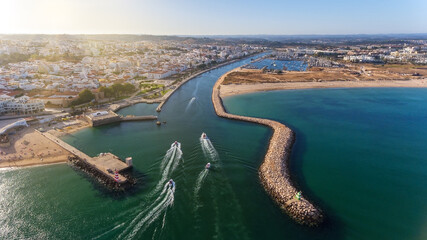 Aerial view from the sky of the Portuguese coastline of the Algarve zone of Lagos city. Boats and...