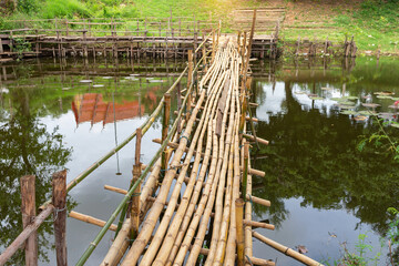 Bamboo bridge on an irrigation canal in the countryside,  wooden bamboo