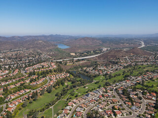 Aerial view of residential neighborhood surrounded by golf and valley during sunny day in Rancho Bernardo, San Diego County, California. USA. 