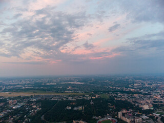Aerial view of Kharkiv city center with Park of Maxim Gorky, stadium and residential multistory buildings with scenic sunset cloudy sky
