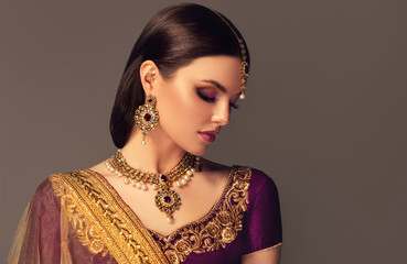 Portrait of beautiful indian girl. Young India woman model with kundan jewelry set. Traditional...