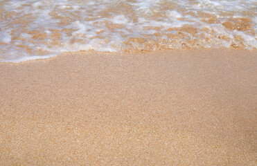 Fototapeta na wymiar Sea waves, sandy beach. Beautiful summer background.