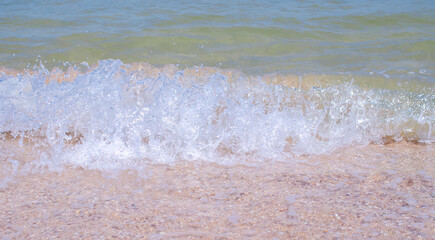Fototapeta na wymiar Waves on the sandy beach. Summer background. Background design, photo wallpapers, covers, screensavers.
