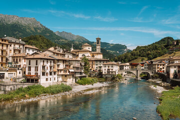 Fototapeta na wymiar San Giovanni Bianco, seen from the Brembo river, Lombardy, Italy. Village of Two Rivers, small town in northern Italy.