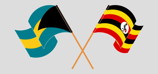 Crossed and waving flags of the Bahamas and Uganda