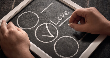 Handwriting choose love on a chalkboard close up.